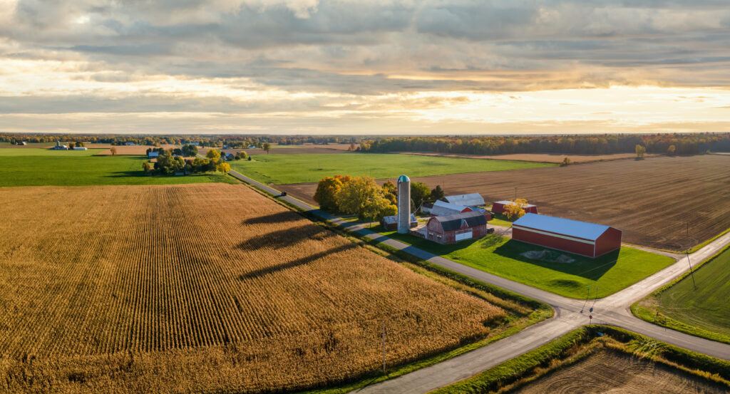 Beautiful sunset light on countryside farm, barn and silo during autumn in central Michigan near Frankenmuth