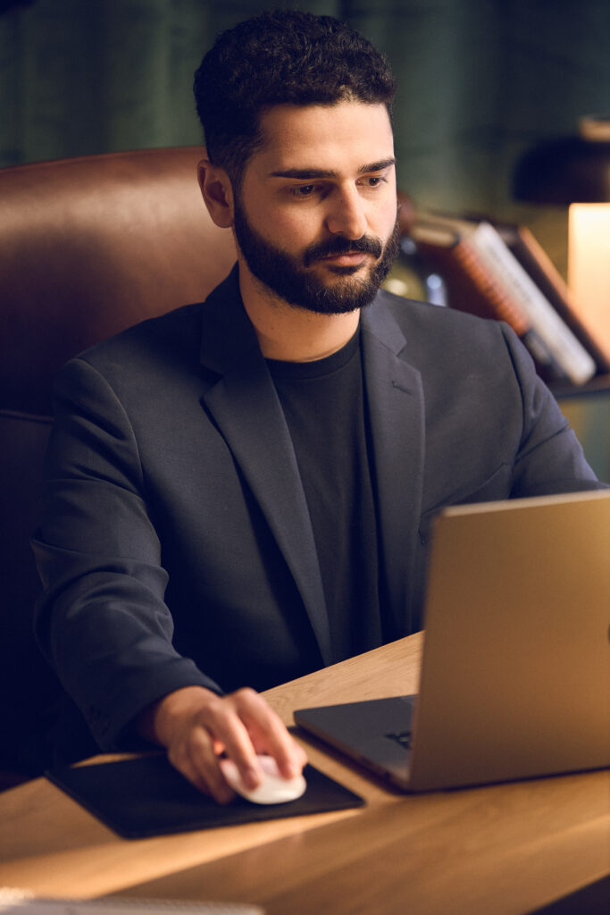 A Titus employee in deep concentration working on his laptop.