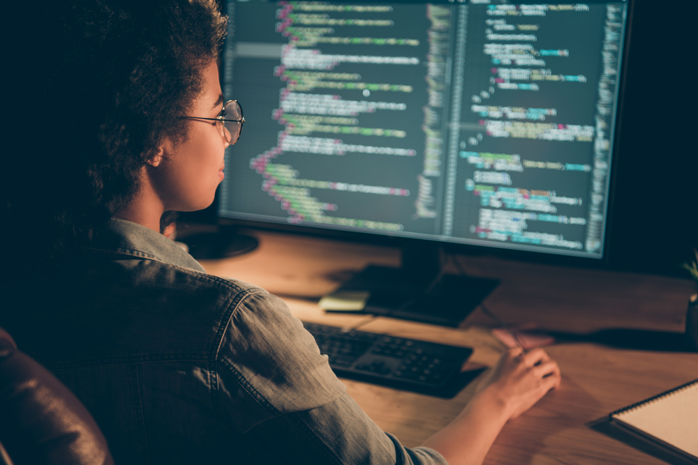 A female software engineer coding a program.