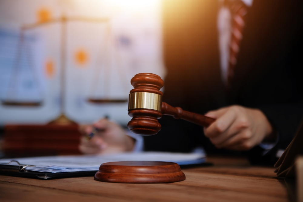 A judge hitting the gavel on a desk